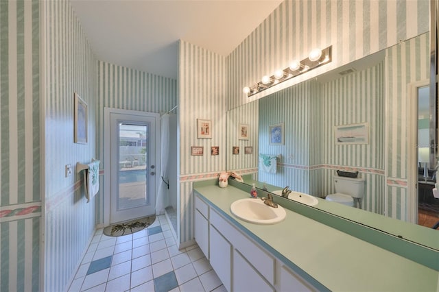 bathroom with vanity, toilet, and tile patterned flooring