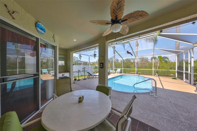 view of pool featuring a lanai, ceiling fan, and a patio area