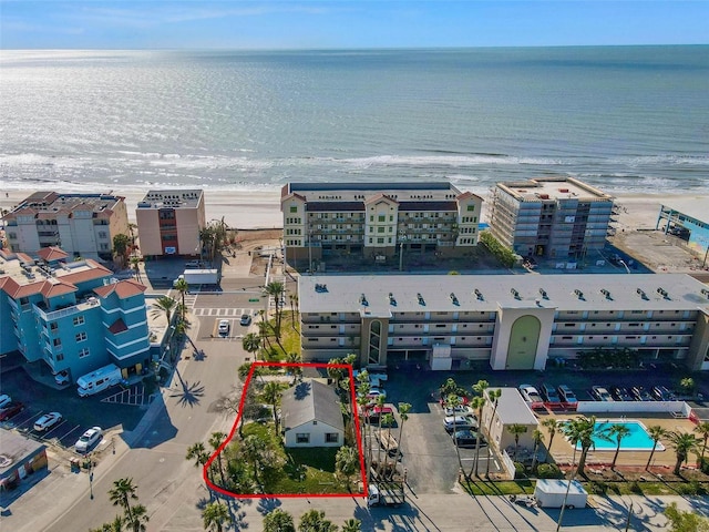 drone / aerial view featuring a water view and a beach view