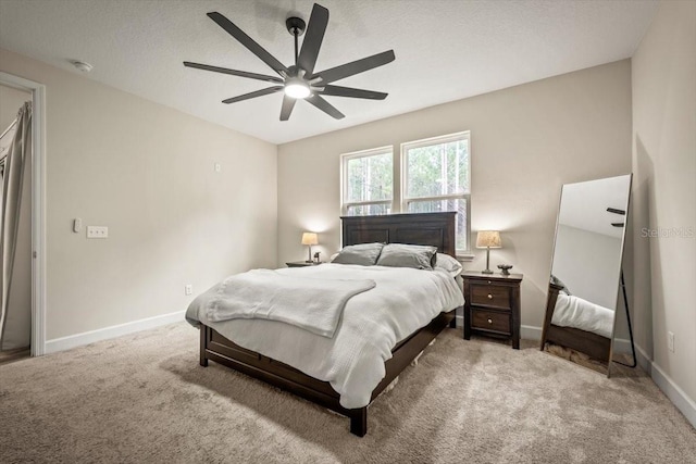 bedroom with carpet, a textured ceiling, and ceiling fan