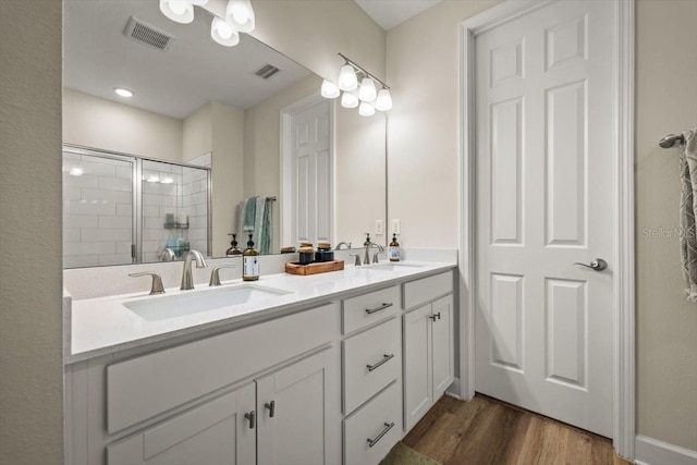 bathroom with vanity, hardwood / wood-style floors, and walk in shower