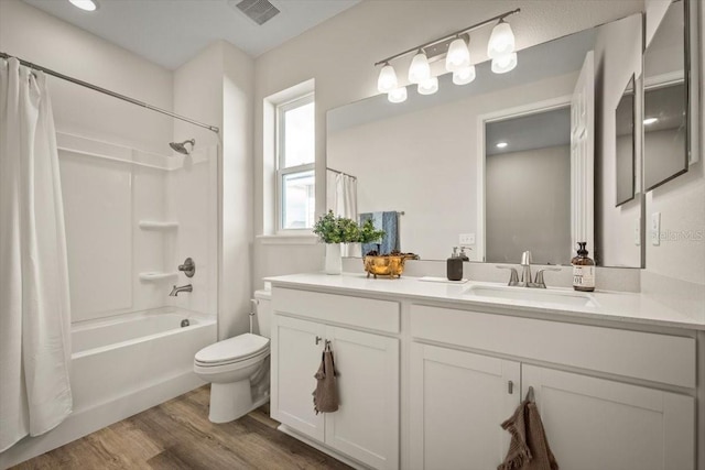 full bathroom with vanity, hardwood / wood-style floors, shower / tub combo with curtain, and toilet