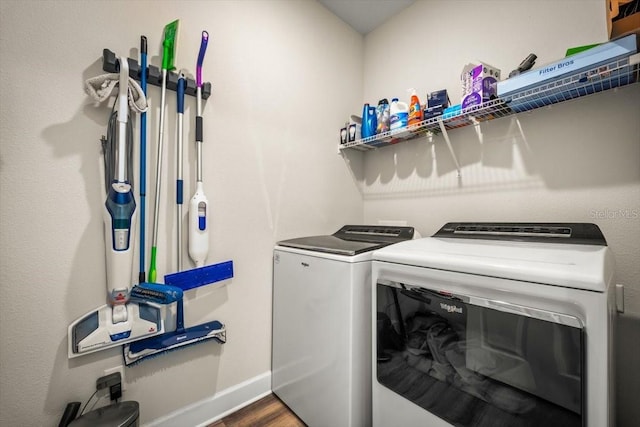 clothes washing area featuring washing machine and dryer and dark hardwood / wood-style floors