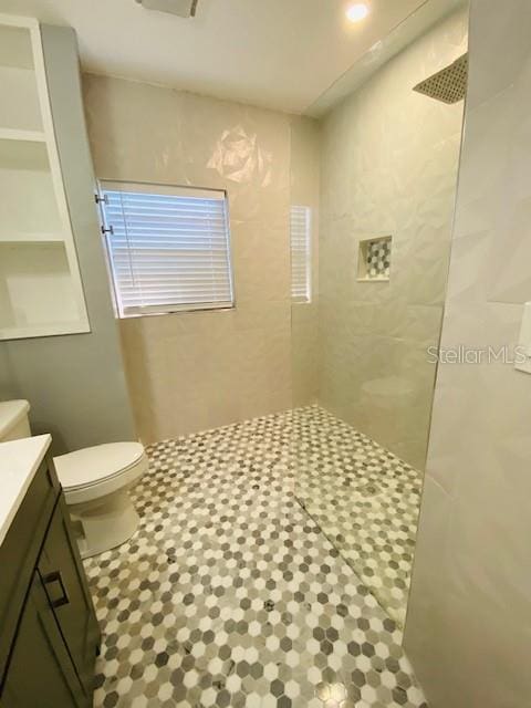 1829 10th St N, Saint Petersburg, FL 33704 - bathroom with vanity, toilet, and a tile shower