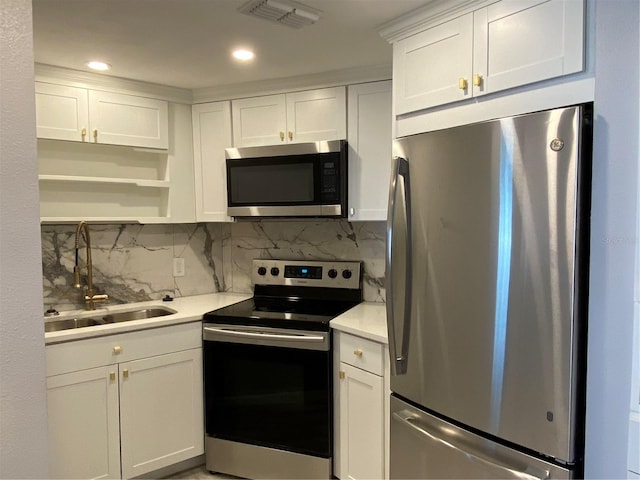 1829 10th St N, Saint Petersburg, FL 33704 - kitchen with appliances with stainless steel finishes, sink, and white cabinets