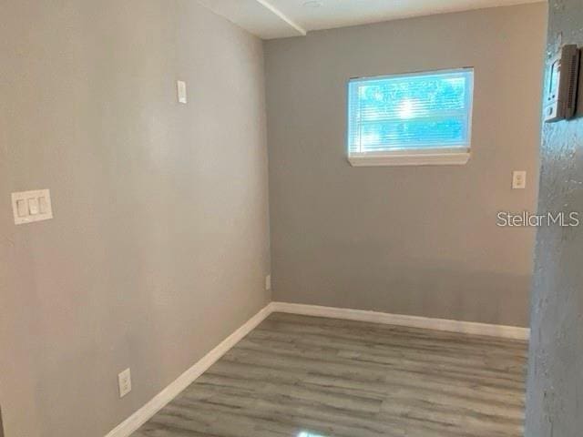 1829 10th St N, Saint Petersburg, FL 33704 - empty room with hardwood / wood-style flooring