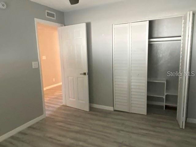 1829 10th St N, Saint Petersburg, FL 33704 - unfurnished bedroom featuring hardwood / wood-style floors and a closet