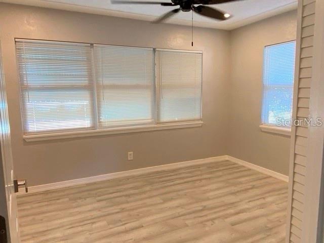1829 10th St N, Saint Petersburg, FL 33704 - spare room featuring ceiling fan, light hardwood / wood-style flooring, and a wealth of natural light