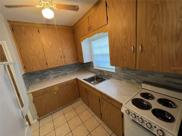 1829 10th St N, Saint Petersburg, FL 33704 - kitchen featuring tasteful backsplash, light tile patterned floors, sink, and electric range