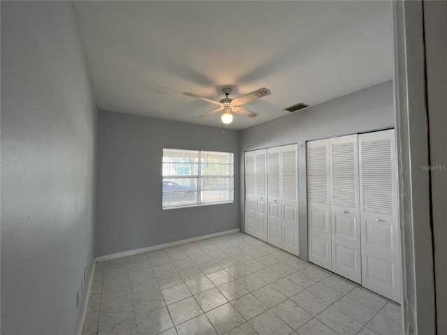 1829 10th St N, Saint Petersburg, FL 33704 - unfurnished bedroom with multiple closets and ceiling fan