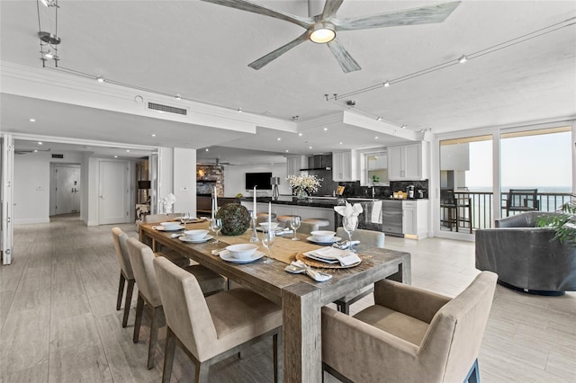 dining space with ornamental molding, a textured ceiling, and ceiling fan