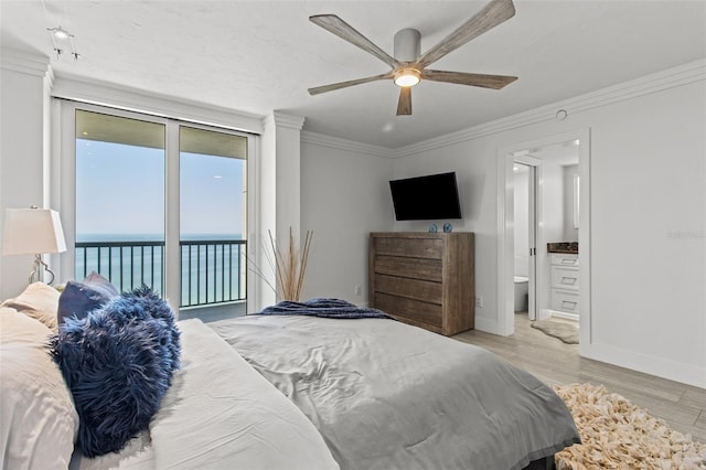 bedroom with connected bathroom, a water view, light hardwood / wood-style flooring, ornamental molding, and access to exterior