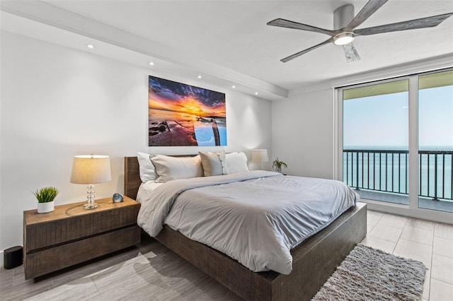 bedroom with a water view, ceiling fan, and access to exterior