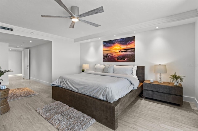 bedroom with ceiling fan, ornamental molding, and light hardwood / wood-style floors