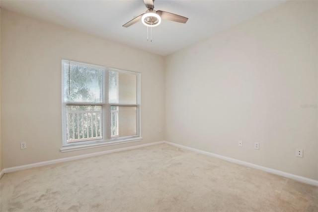 empty room with light carpet and ceiling fan