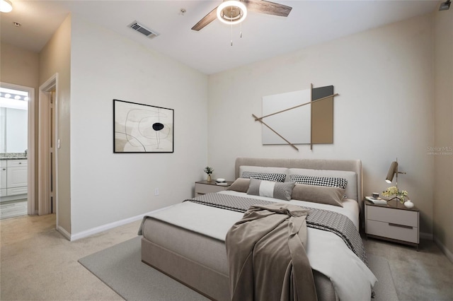 bedroom featuring connected bathroom, light colored carpet, and ceiling fan