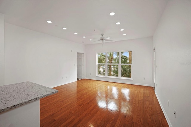 unfurnished room featuring hardwood / wood-style floors and ceiling fan