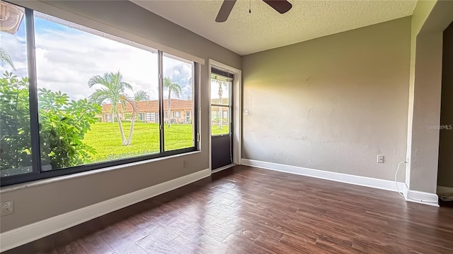 spare room with dark hardwood / wood-style flooring, ceiling fan, and a textured ceiling