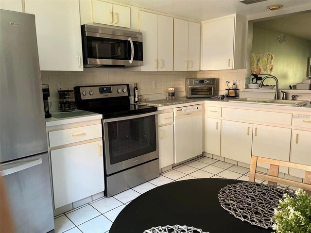 kitchen featuring sink, white cabinets, and appliances with stainless steel finishes