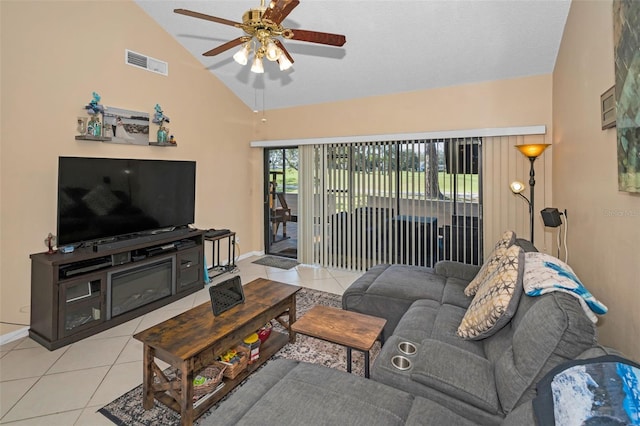 living room with lofted ceiling, light tile patterned floors, and ceiling fan