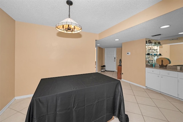 interior space with indoor bar and a textured ceiling