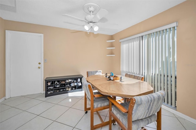 tiled dining room featuring ceiling fan