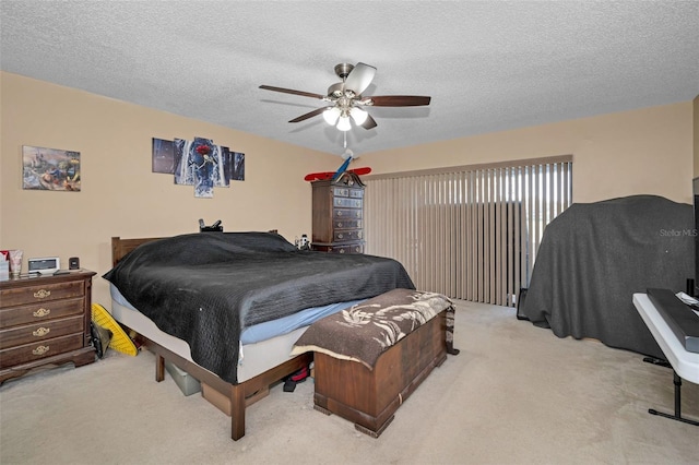 bedroom with light carpet, ceiling fan, and a textured ceiling