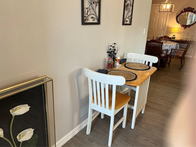 dining space with dark hardwood / wood-style flooring