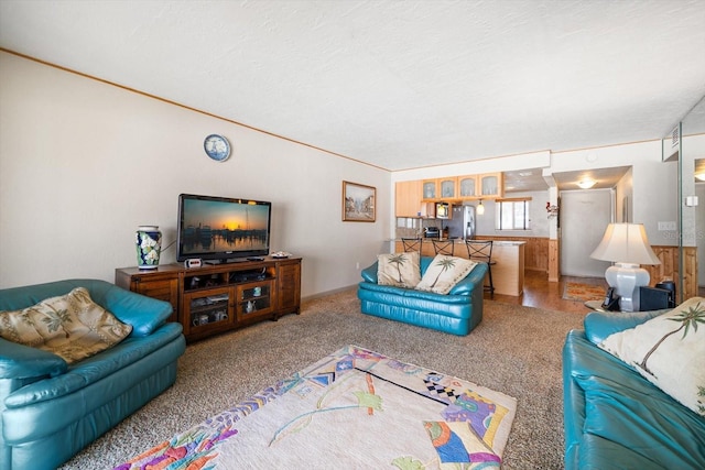 living room with ornamental molding and carpet flooring