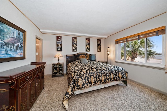 carpeted bedroom with ornamental molding