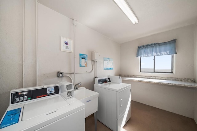 clothes washing area with washer and clothes dryer and dark carpet