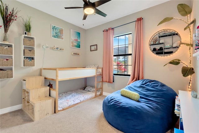 bedroom featuring baseboards, ceiling fan, and light carpet