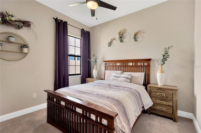 bedroom with light colored carpet, a ceiling fan, and baseboards