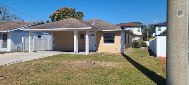 view of front of property with a front yard and a carport