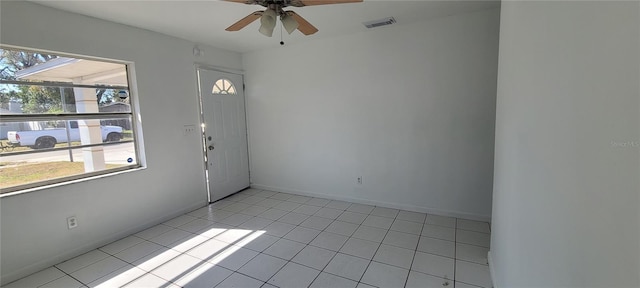 tiled empty room featuring ceiling fan