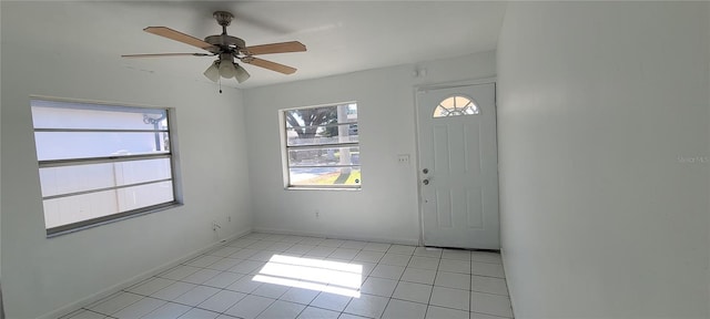 foyer entrance with light tile patterned floors and ceiling fan