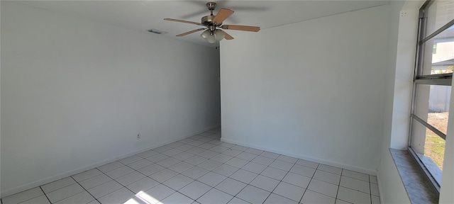 spare room with ceiling fan and plenty of natural light