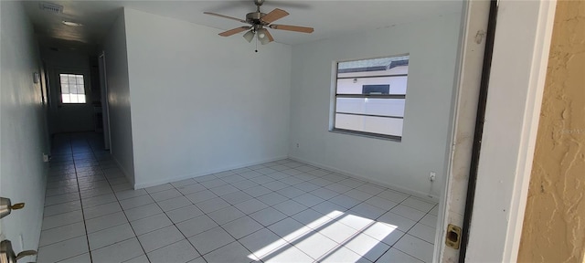 spare room featuring light tile patterned floors and ceiling fan