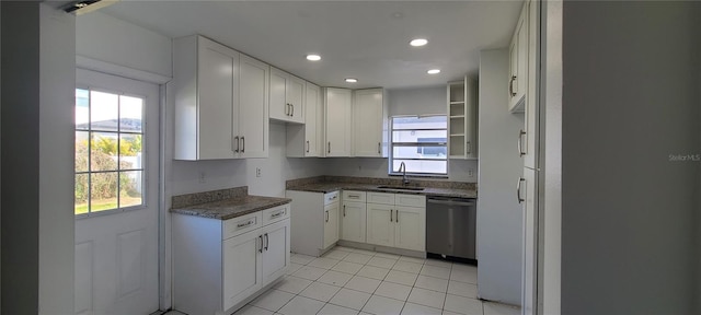 kitchen with white cabinetry, dishwasher, sink, and light tile patterned floors