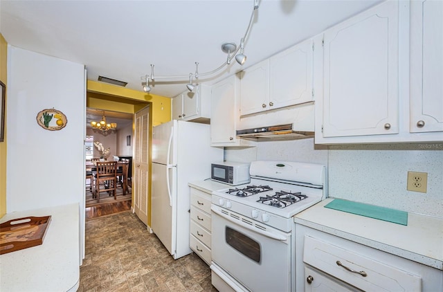 kitchen featuring a chandelier, white appliances, light countertops, and white cabinets