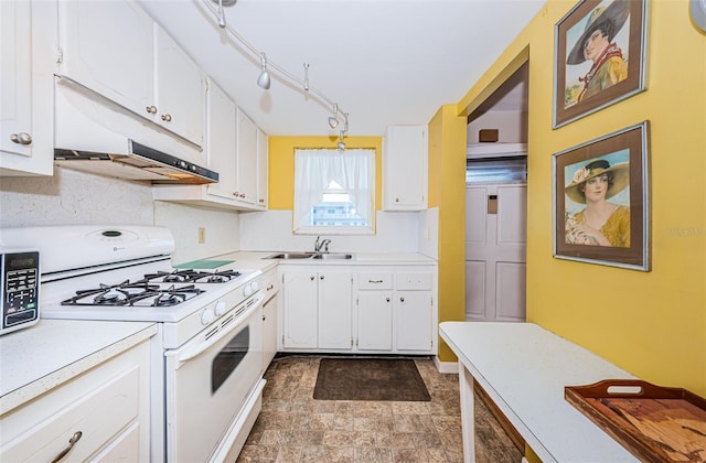 kitchen with white range with gas stovetop, light countertops, and white cabinetry