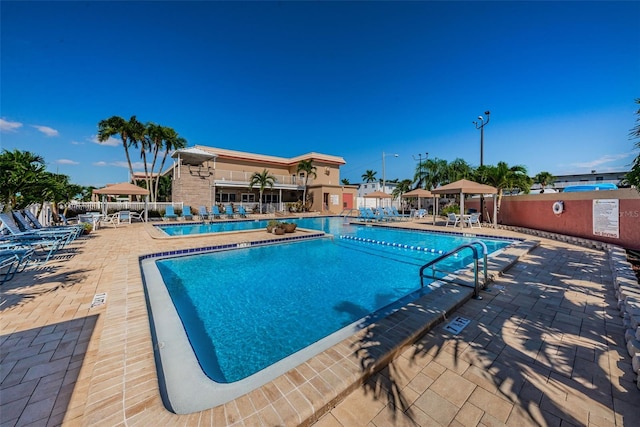 pool featuring a patio area, fence, and a gazebo