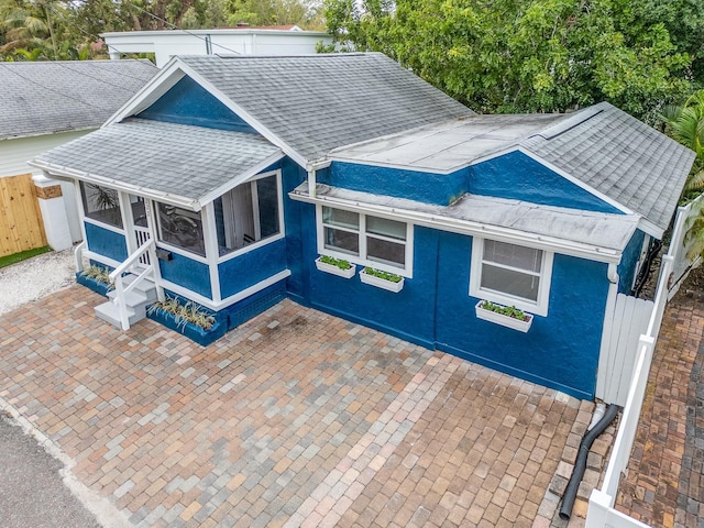 view of front of home with a patio and a sunroom