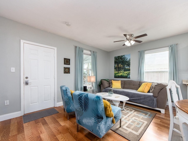 living room with ceiling fan, hardwood / wood-style floors, and a wealth of natural light