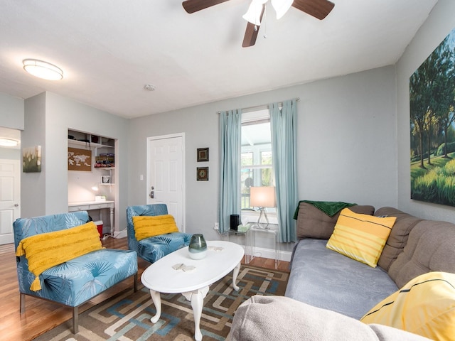 living room featuring hardwood / wood-style floors and ceiling fan