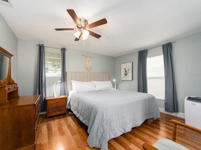 bedroom with light hardwood / wood-style flooring and ceiling fan