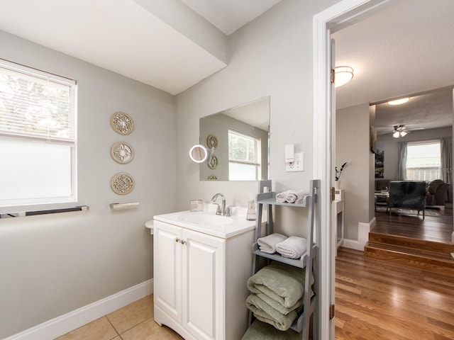 bathroom with hardwood / wood-style flooring, ceiling fan, and vanity