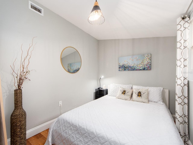 bedroom with wood-type flooring