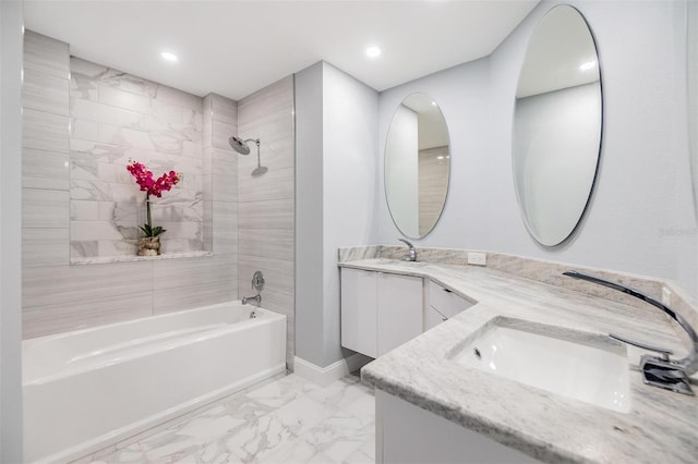 bathroom with tiled shower / bath combo and vanity