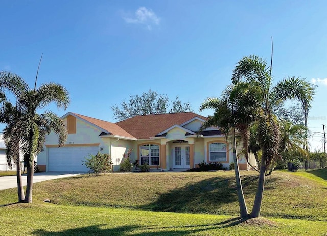 ranch-style house with a garage, a front yard, and french doors